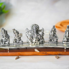 Instrument playing 5 ganesha idol on a leaf