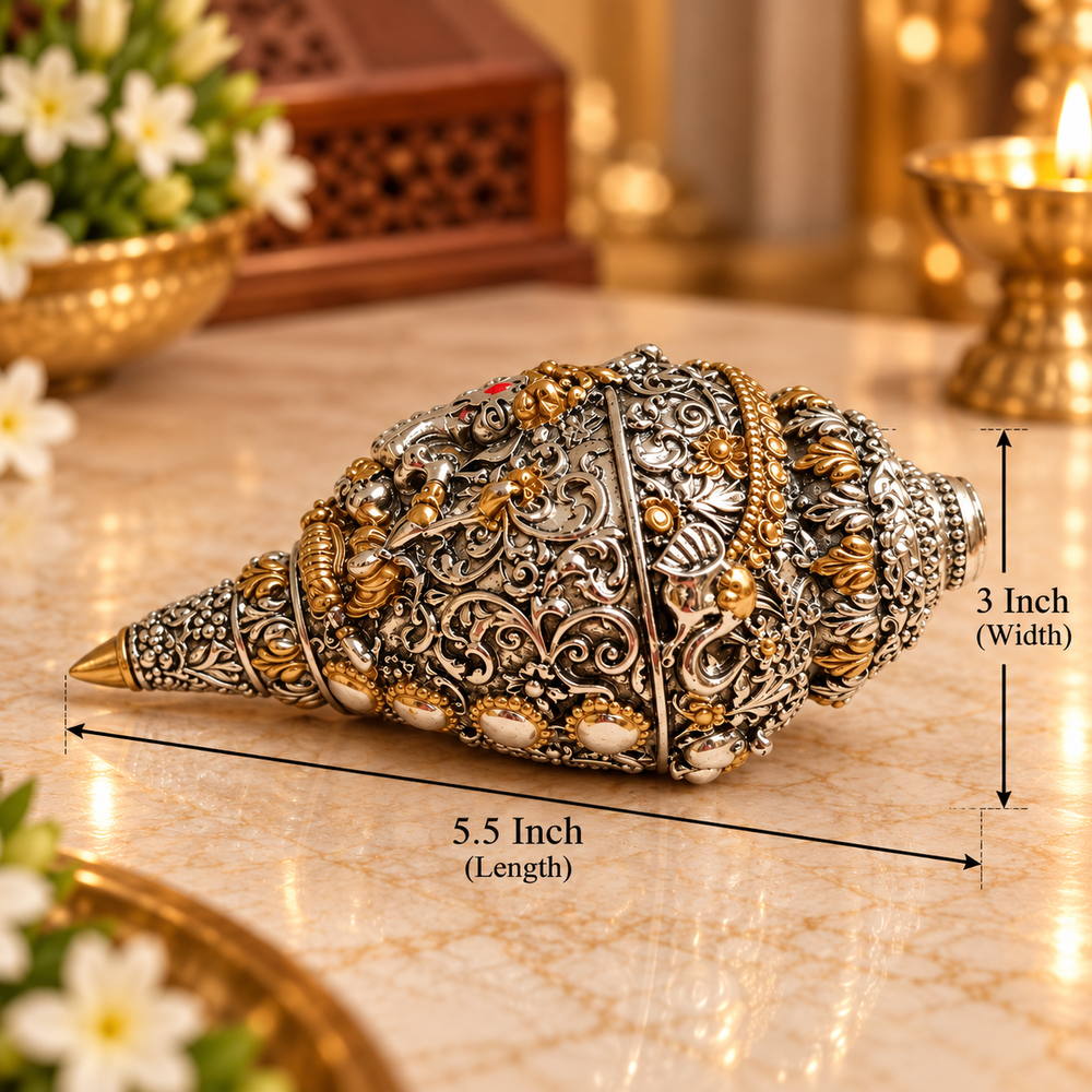 An ornate silver-toned shell-shaped decorative object with intricate gold and white detailing, shown on a marble surface with dimension lines indicating 5.5 inch length and 3 inch width.