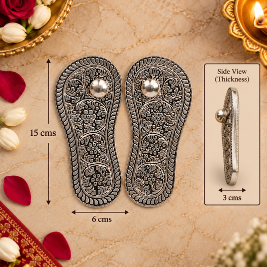 A pair of ornate silver-toned metal shoe insoles with detailed floral engravings and a central round stud, shown on a beige textured background with decorative flowers and a side view inset. Measurement labels indicate 15 cm height, 6 cm width, and 3 cm side thickness.
