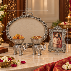 Ornate silver-toned decorative set on a marble table, including an oval tray, two elephant-shaped bowls holding sweets, and a framed picture. White dimension lines and labels show measurements: 37 cm width, 21 cm height, and 13 cm frame width.
