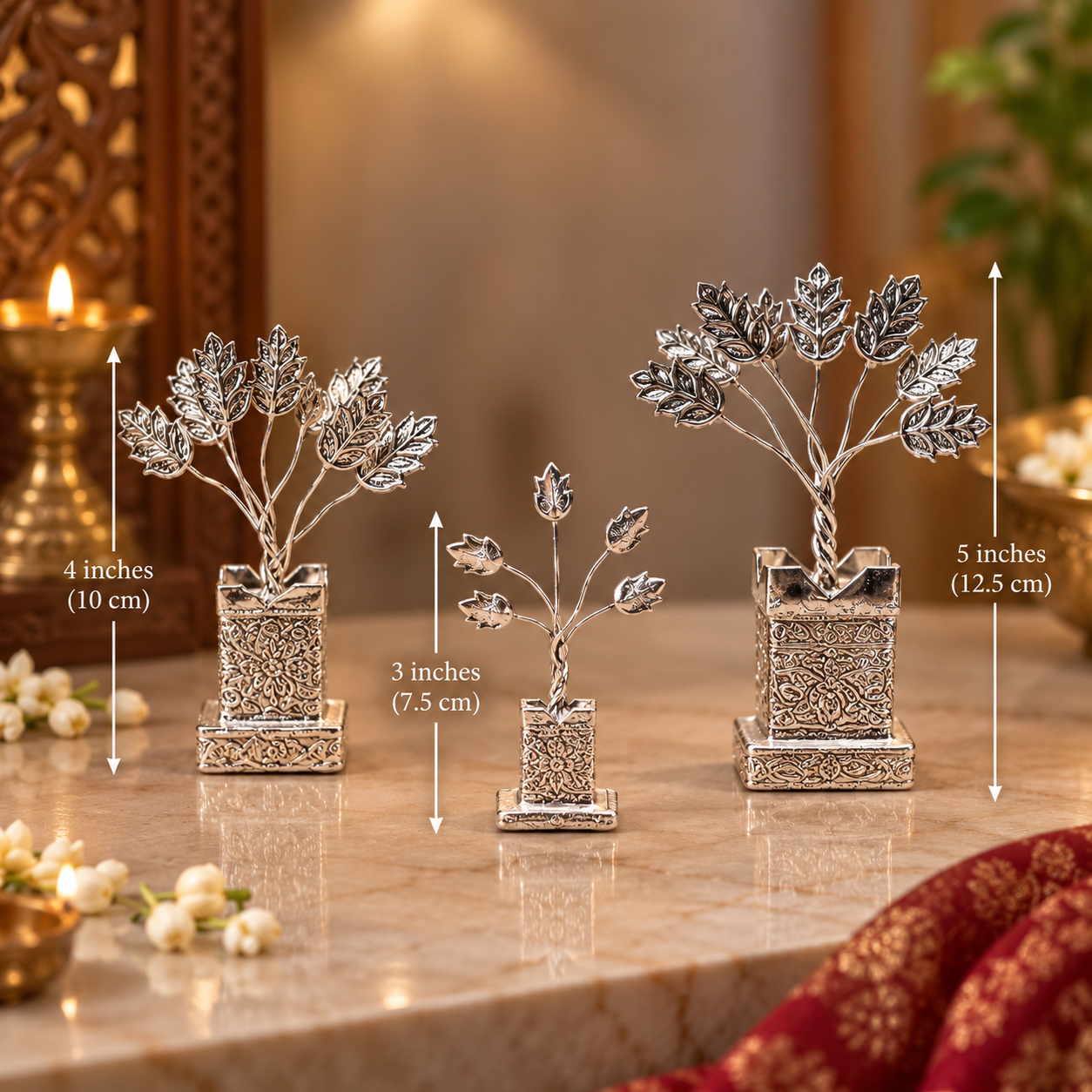 Three silver decorative tree ornaments in different sizes displayed on a marble surface with dimension arrows and text indicating 4 inches, 3 inches, and 5 inches.