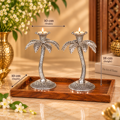 Two silver palm tree candle holders on a wooden tray, with overlaid dimension arrows and text showing 10 cm width, 18 cm height, and 10 cm depth.