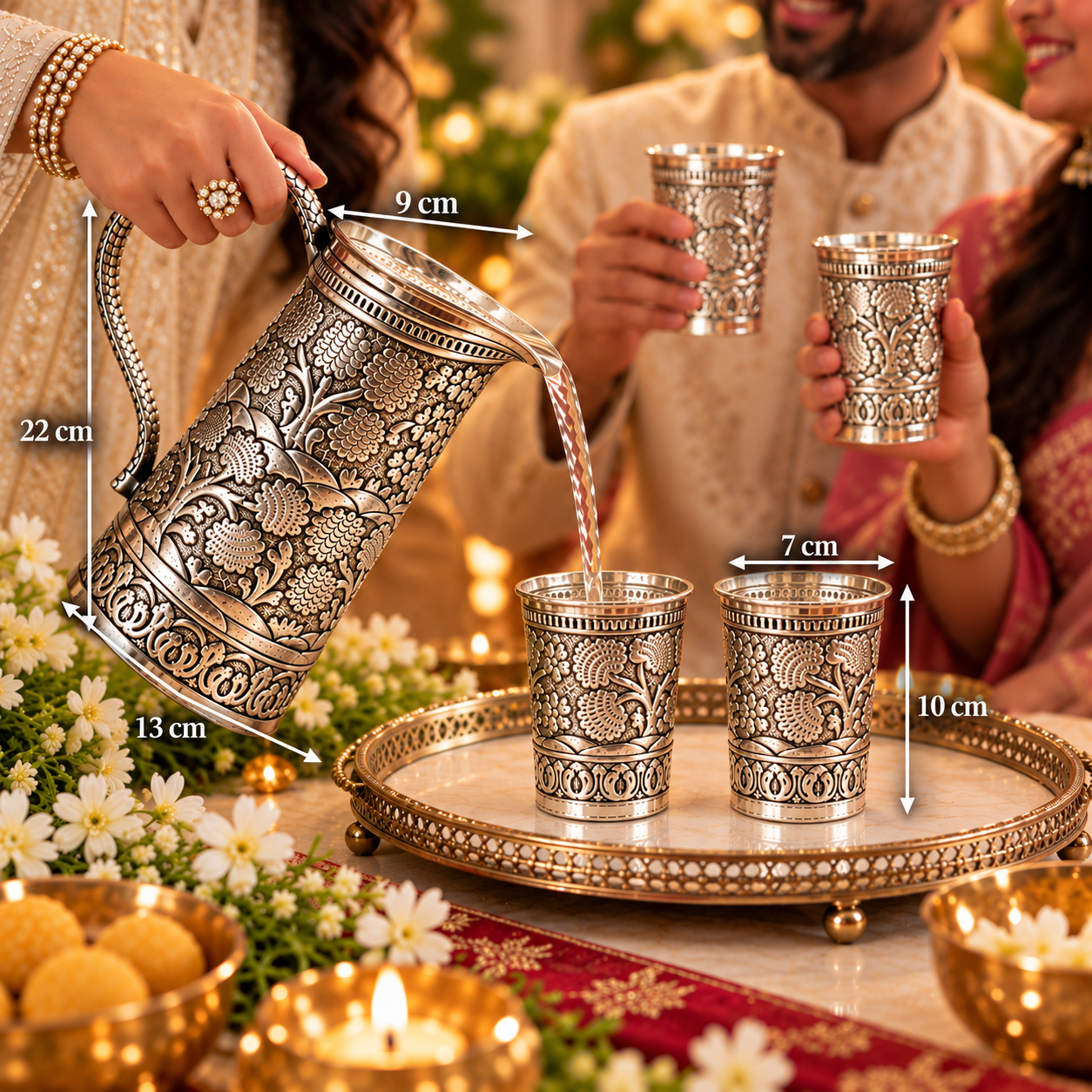 An ornate silver-toned metal teapot with intricate floral engravings is shown pouring liquid into two matching engraved metal cups on a decorative tray, with people holding additional cups in the background. Measurement arrows and labels indicate the teapot's dimensions (22 cm, 13 cm, 9 cm, 7 cm, 10 cm).