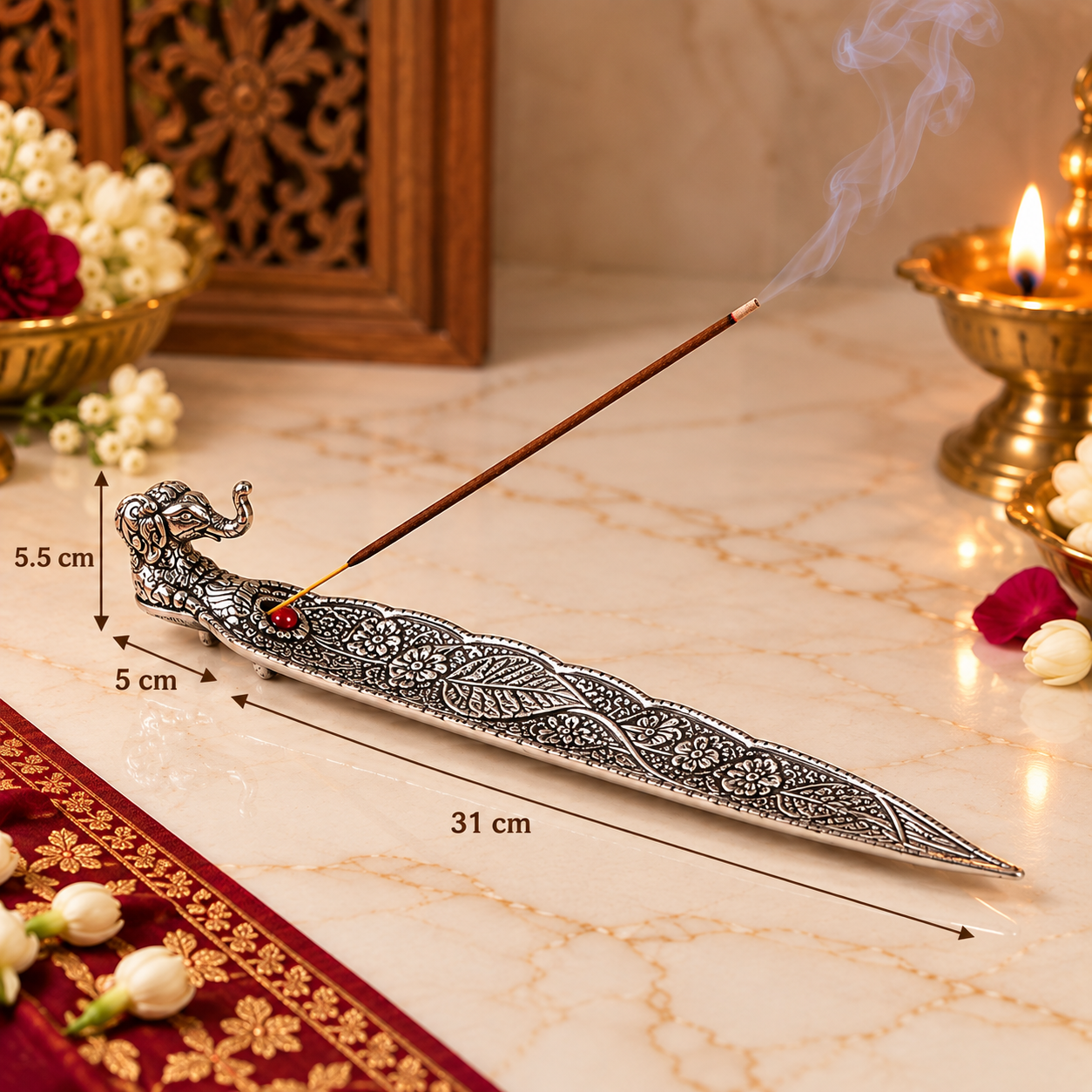 An ornate silver-toned metal incense holder shaped like a curved sword or dagger, with a smoking incense stick resting across it. The image includes dimension callouts showing 31 cm length, 5 cm width, and 5.