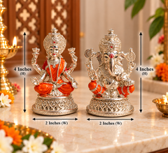 Two ornate silver deity figurines on a marble surface with overlaid dimension arrows and text showing 4 inches height and 2 inches width. The left figurine is seated in orange robes, and the right figurine is more detailed in silver with small orange accents.