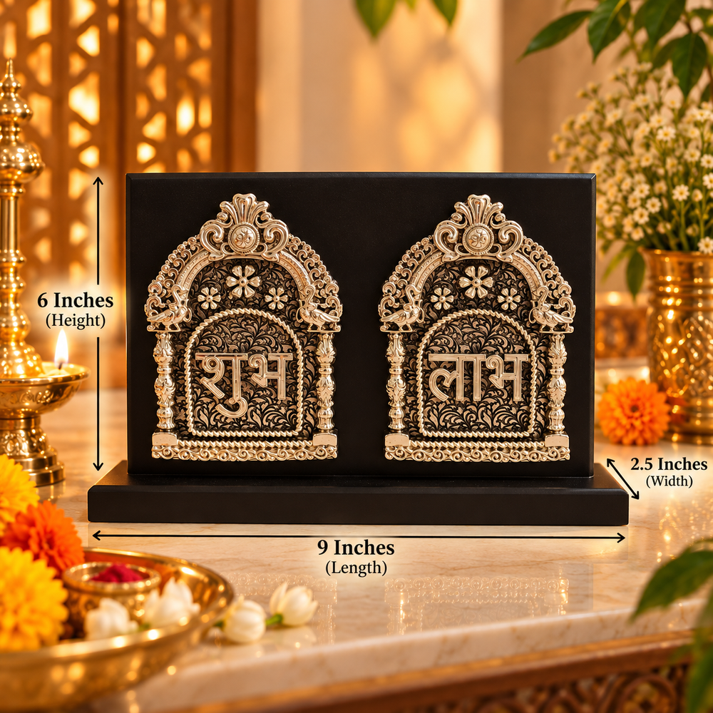 A black rectangular decorative plaque or box with two ornate silver arch motifs and Devanagari text, shown on a tabletop with dimension callouts reading 9 inches length, 6 inches height, and 2.5 inches width.