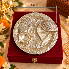 An ornate round silver-toned plate with embossed floral and leaf motifs, shown resting on a red velvet box. A white measurement overlay indicates the plate is 6 inch in diameter.