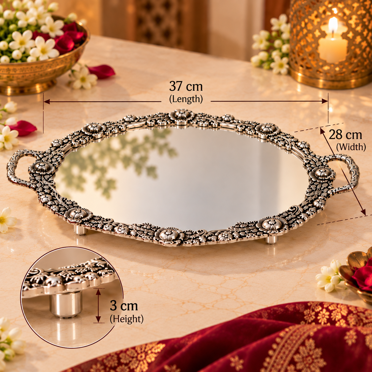 An ornate silver oval tray with a mirror center, decorative filigree border, and small feet, shown on a beige marble surface with overlaid dimension labels for length, width, and height. A circular inset highlights the 3 cm height detail.