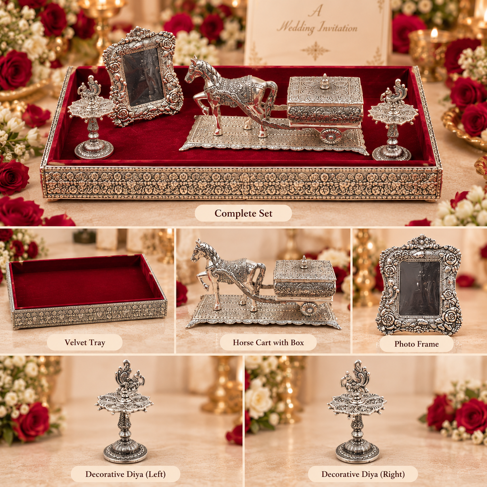 A coordinated wedding keepsake set displayed in a velvet-lined decorative tray, with six labeled close-up panels showing the contents: a complete set, the velvet tray, a horse cart box, a photo frame, and two decorative diya holders. The pieces are ornate silver-toned metal with red velvet interior and floral detailing, surrounded by roses and candles.