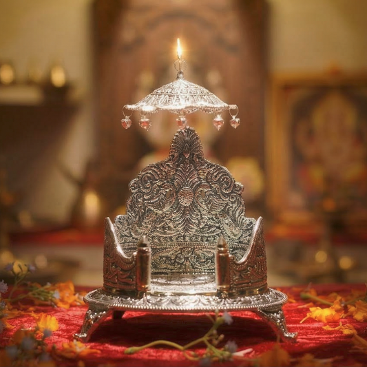 Decorative silver lamp with a candle on a red cloth, blurred background