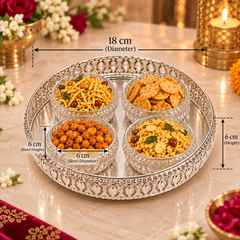 A decorative silver-plated serving tray with four clear glass bowls filled with Indian snacks, shown on a marble table with overlaid dimension labels indicating 18 cm diameter, 6 cm bowl diameter, and 6 cm bowl height.